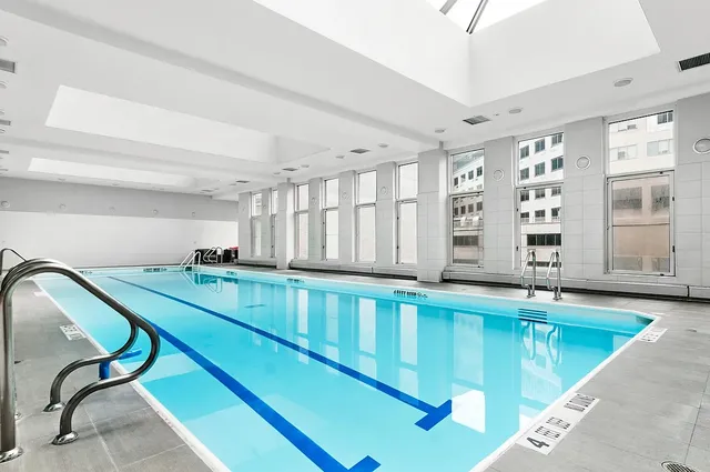 a kitchen with table chairs cabinets and a large window