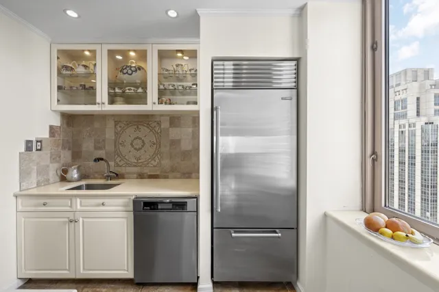 a kitchen with a refrigerator and a sink