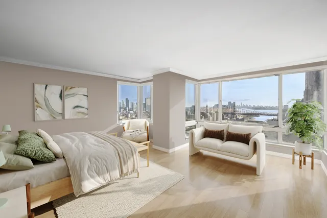 a bedroom with furniture and a large window