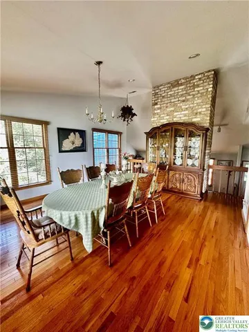 a living room with furniture dining table and a flat screen tv