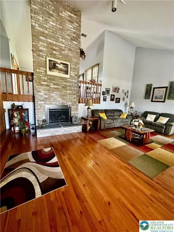 a living room with furniture a fireplace and gym equipment