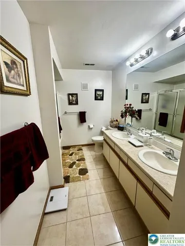 a large white room with a mirror and a sink