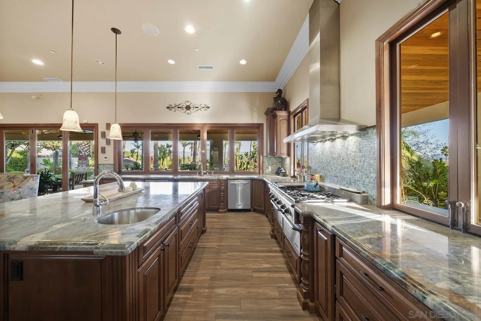 3128 Los Verdes Drive Fallbrook, CA 92028 - Photo 27 of 70 a kitchen with stainless steel appliances granite countertop sink stove and large window