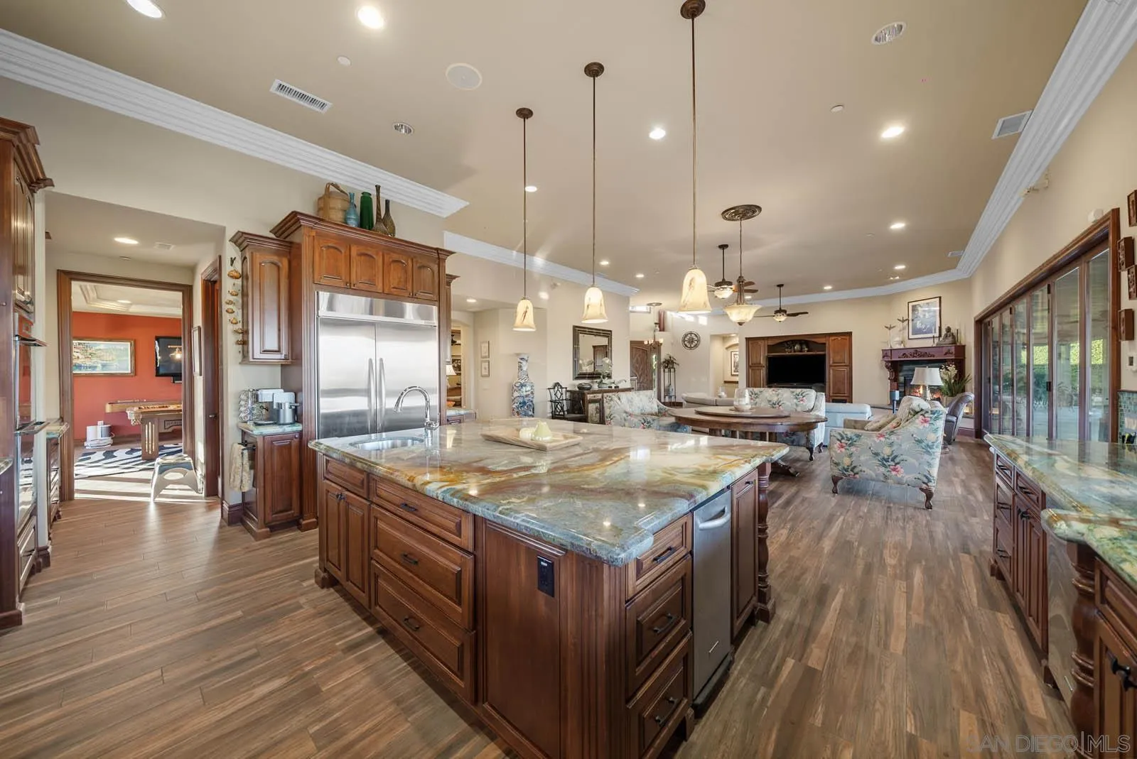 3128 Los Verdes Drive Fallbrook, CA 92028 - Photo 6 of 70 a kitchen with stainless steel appliances granite countertop a stove and a wooden floors