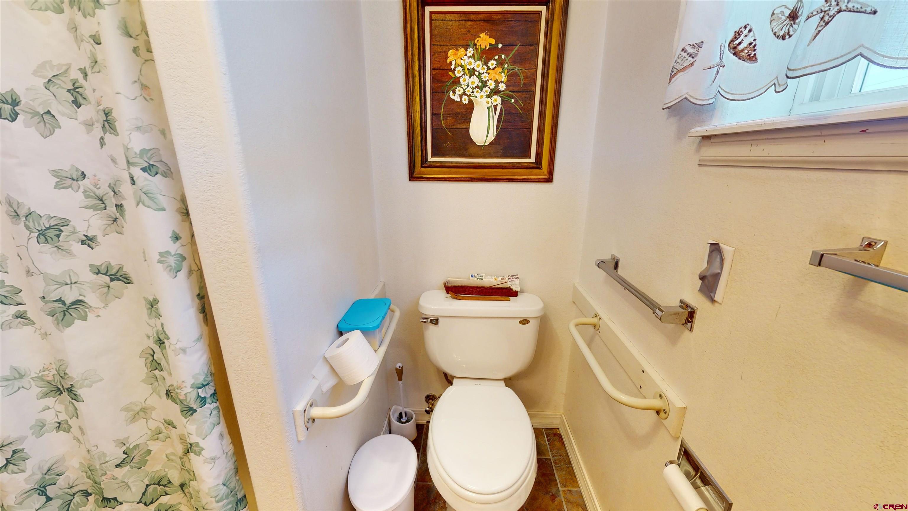 16459 Grange Road Paonia, CO 81428 - Photo 16 of 35 a white toilet sitting next to a shower curtain