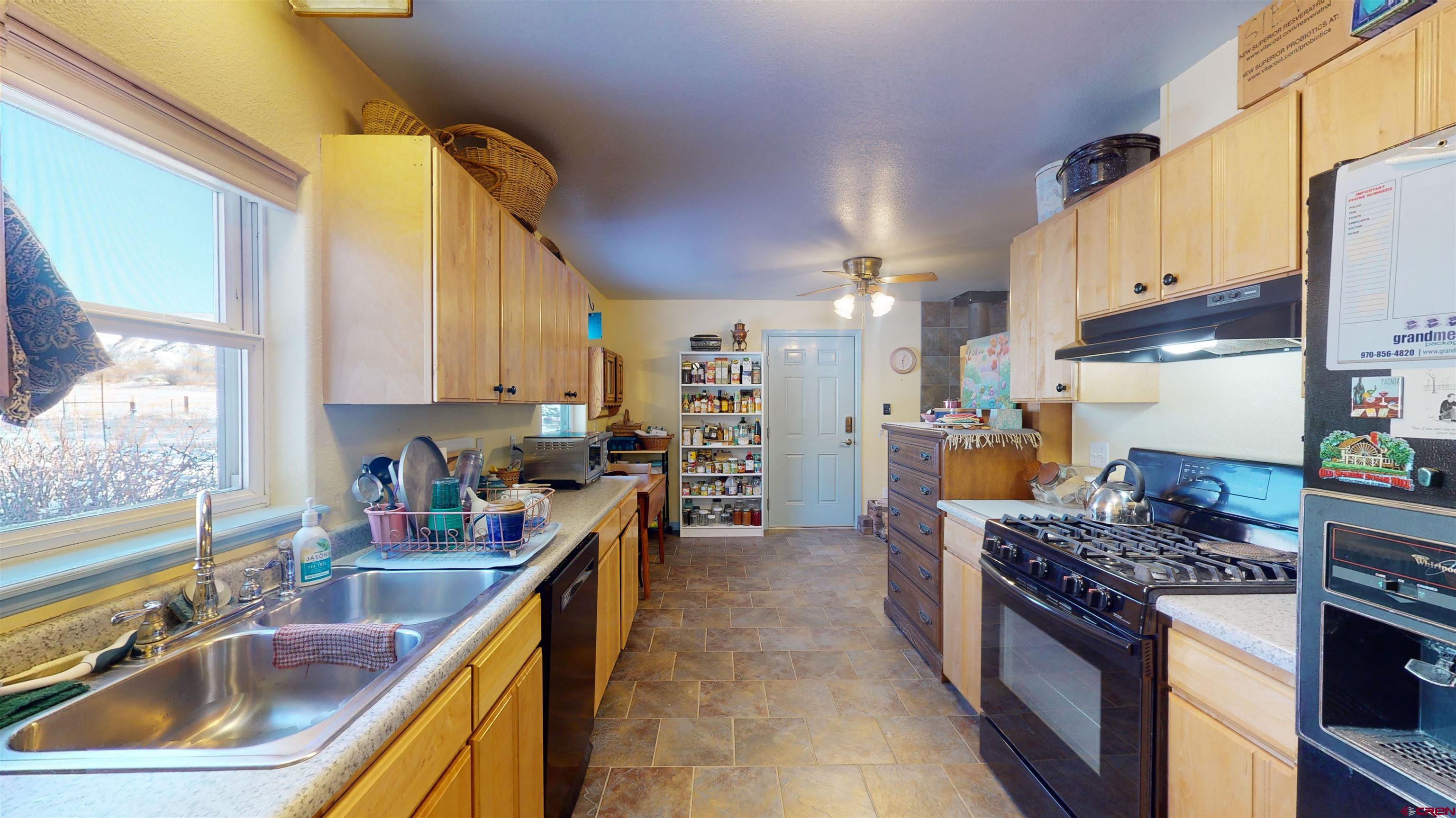 16459 Grange Road Paonia, CO 81428 - Photo 20 of 35 a kitchen with stainless steel appliances granite countertop a sink stove and refrigerator