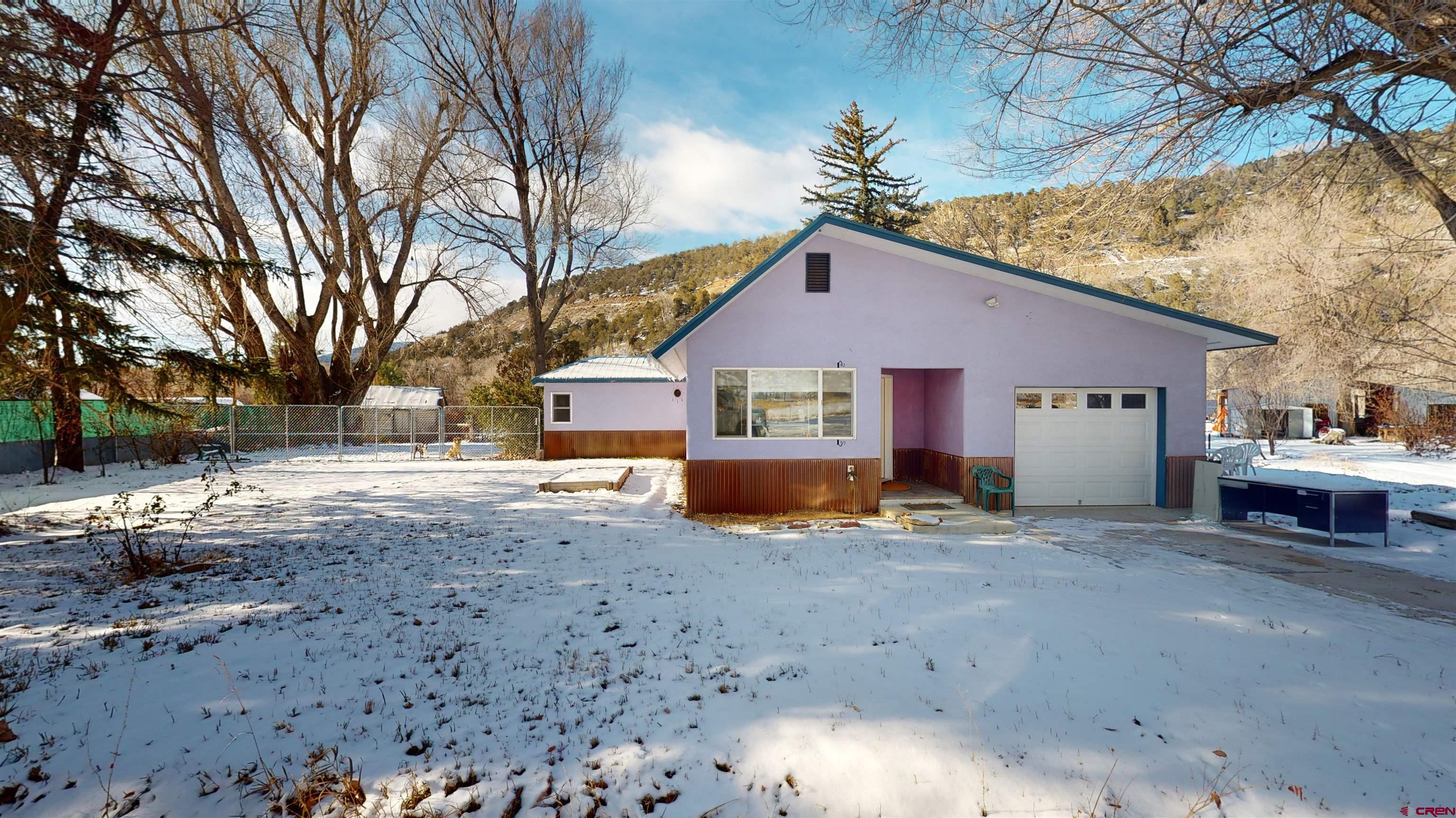 16459 Grange Road Paonia, CO 81428 - Photo 3 of 35 a view of a house with a yard covered in snow