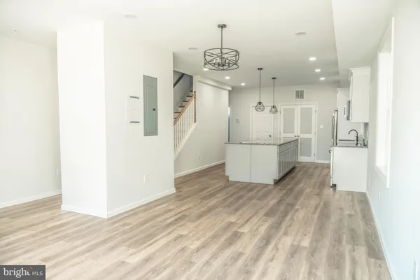a bathroom with a granite countertop sink a toilet and bathtub