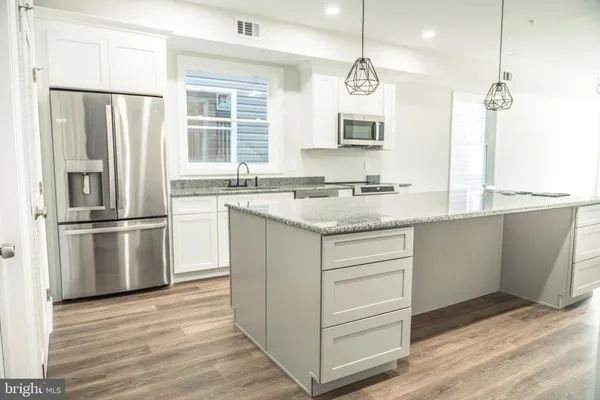 a bathroom with a granite countertop toilet a sink and a bathtub
