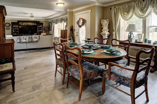 a view of a dining room with furniture and a flat screen tv