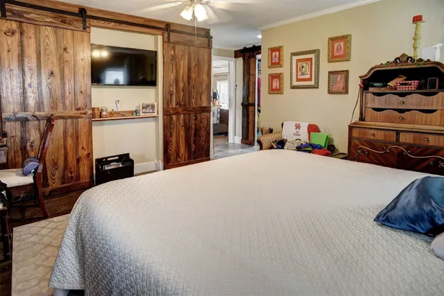 a bedroom with a bed and a tv