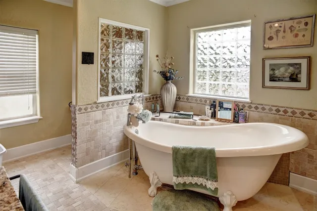a white bath tub sitting next to a window
