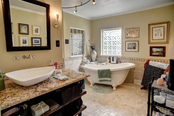 a living room with furniture two window and a flat screen tv