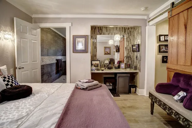 a bedroom with a bed and glass windows