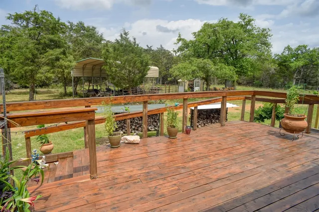 a view of a balcony with chairs and wooden floor