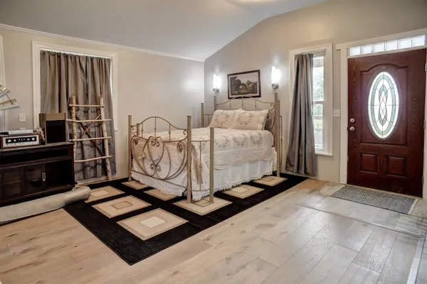 a living room with a bed furniture and a flat screen tv