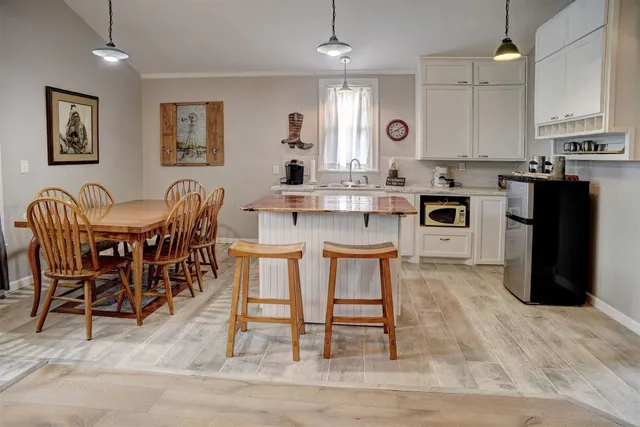 a large kitchen with a table and chairs