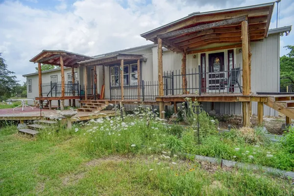 a backyard of a house with yard and outdoor seating