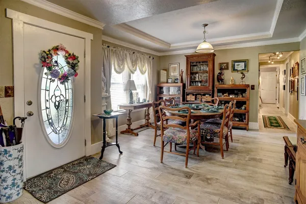 a view of a dining room with furniture and chandelier