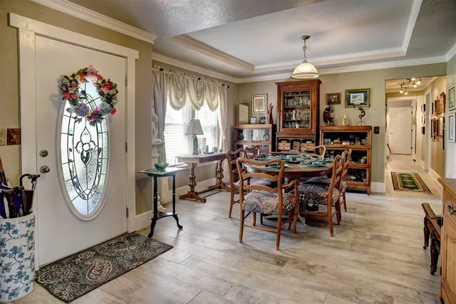 a view of a dining room with furniture and chandelier