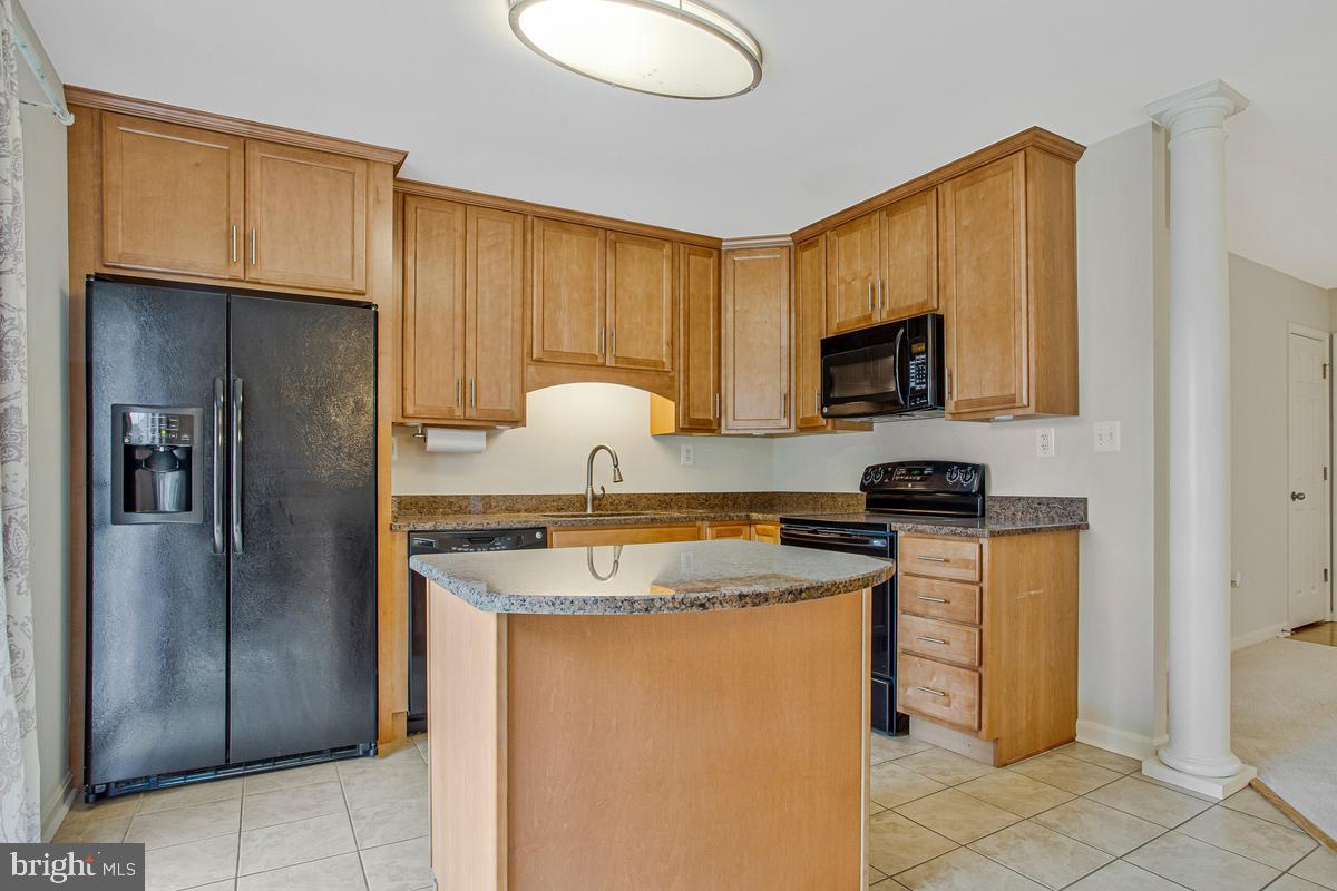 1420 Knight Avenue Dunkirk, MD 20754 - Photo 6 of 30 a kitchen with stainless steel appliances granite countertop a stove a refrigerator a sink a microwave and island