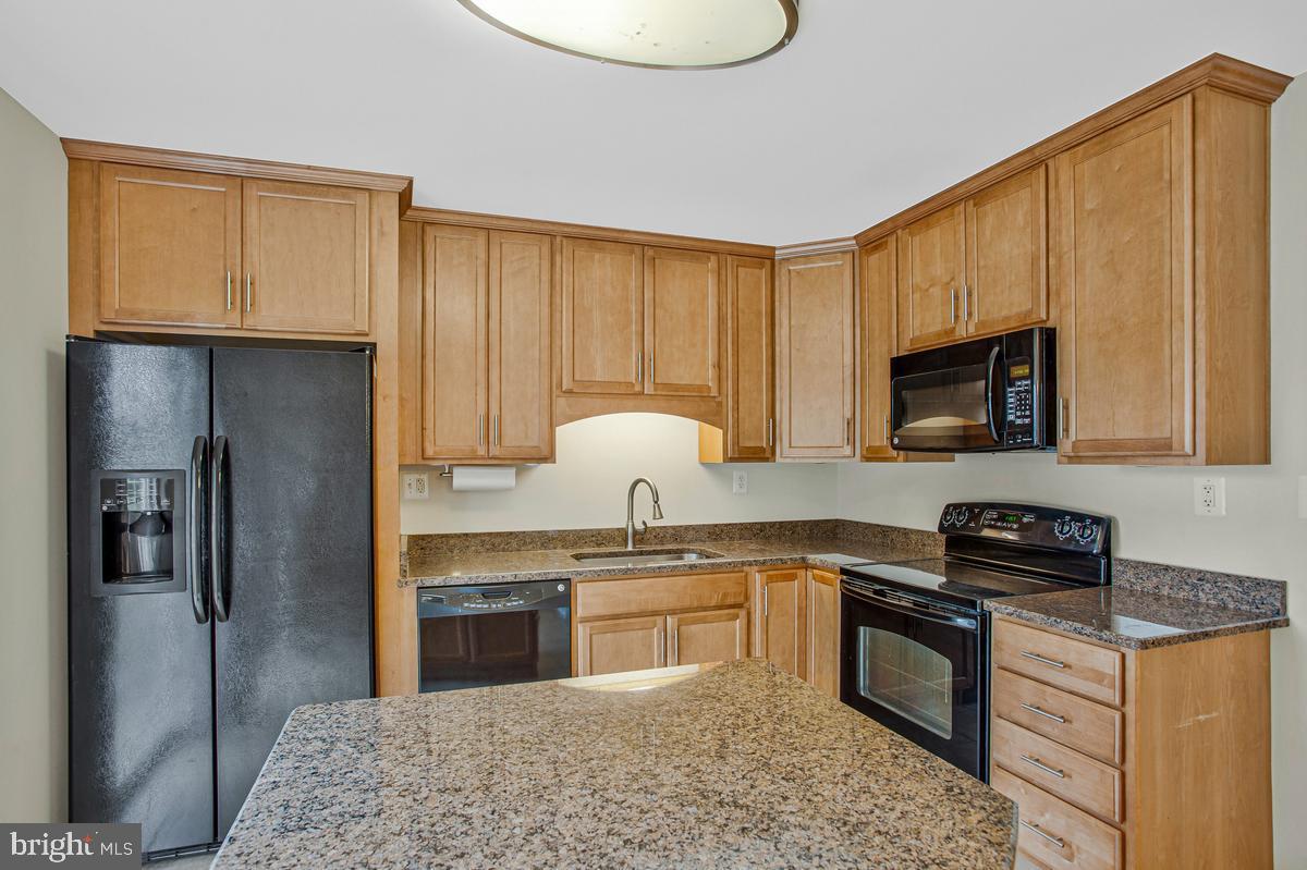 1420 Knight Avenue Dunkirk, MD 20754 - Photo 7 of 30 a kitchen with stainless steel appliances granite countertop a stove a sink and a refrigerator