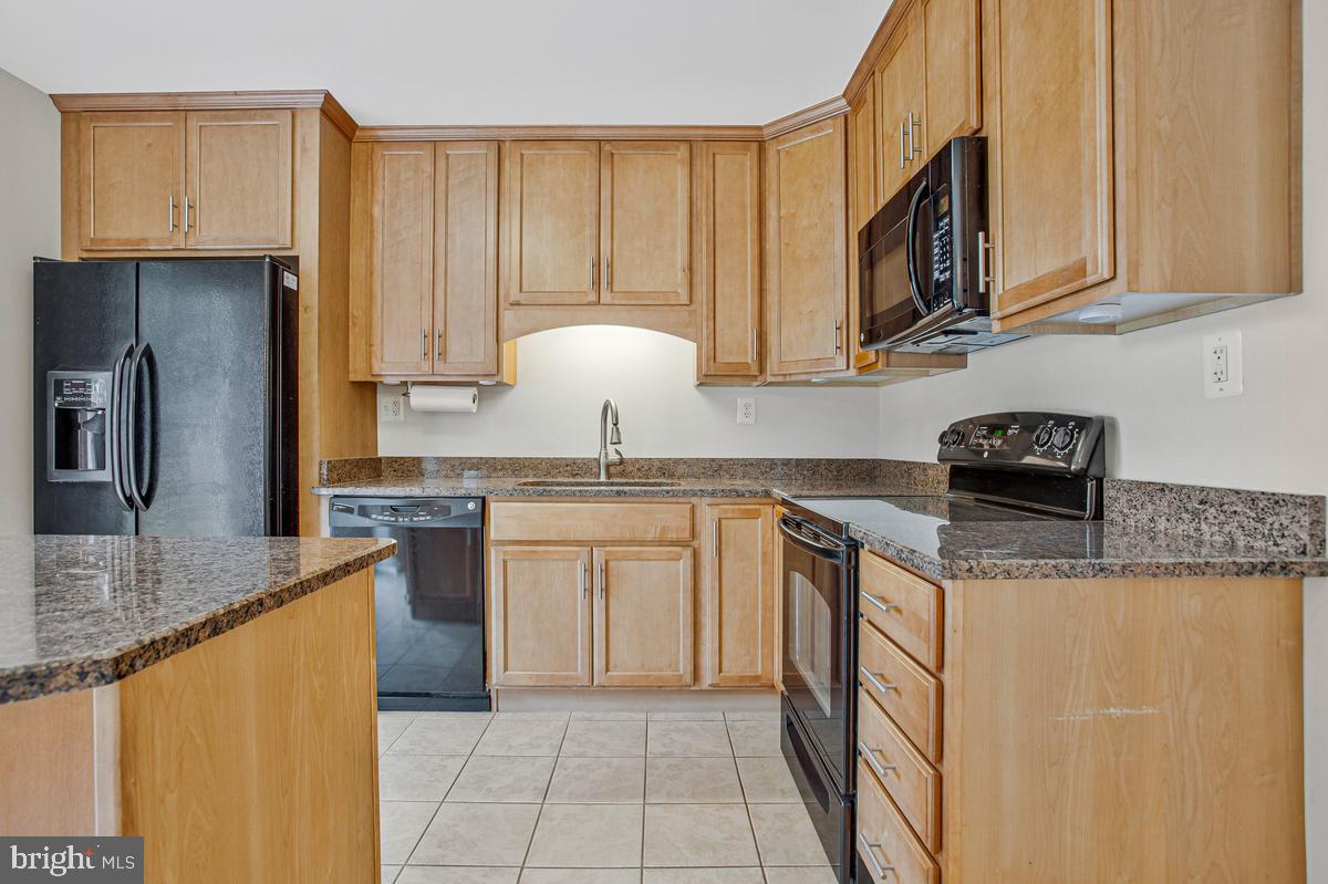 1420 Knight Avenue Dunkirk, MD 20754 - Photo 8 of 30 a kitchen with stainless steel appliances granite countertop a sink stove and cabinets