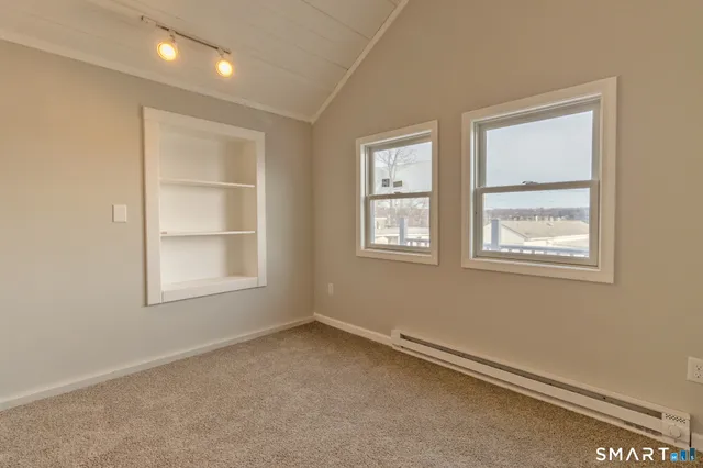 an empty room with a empty space and windows