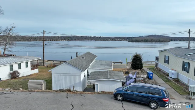 a white house that has a tree in front of it