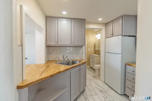 a kitchen with a refrigerator and a sink