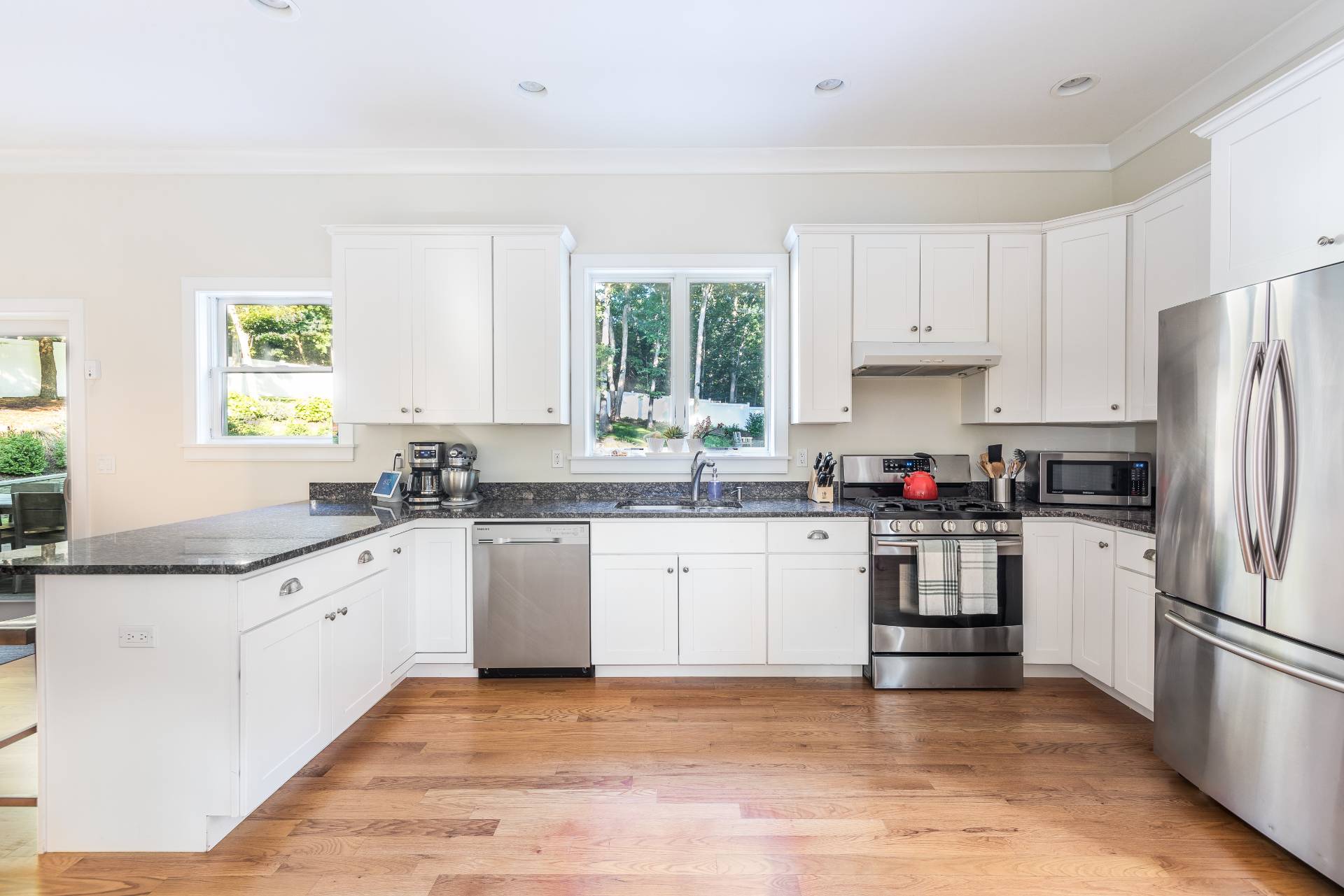 27 Kings Point Road East Hampton, NY 11937 - Photo 6 of 17 a kitchen with granite countertop appliances a sink cabinets and a window