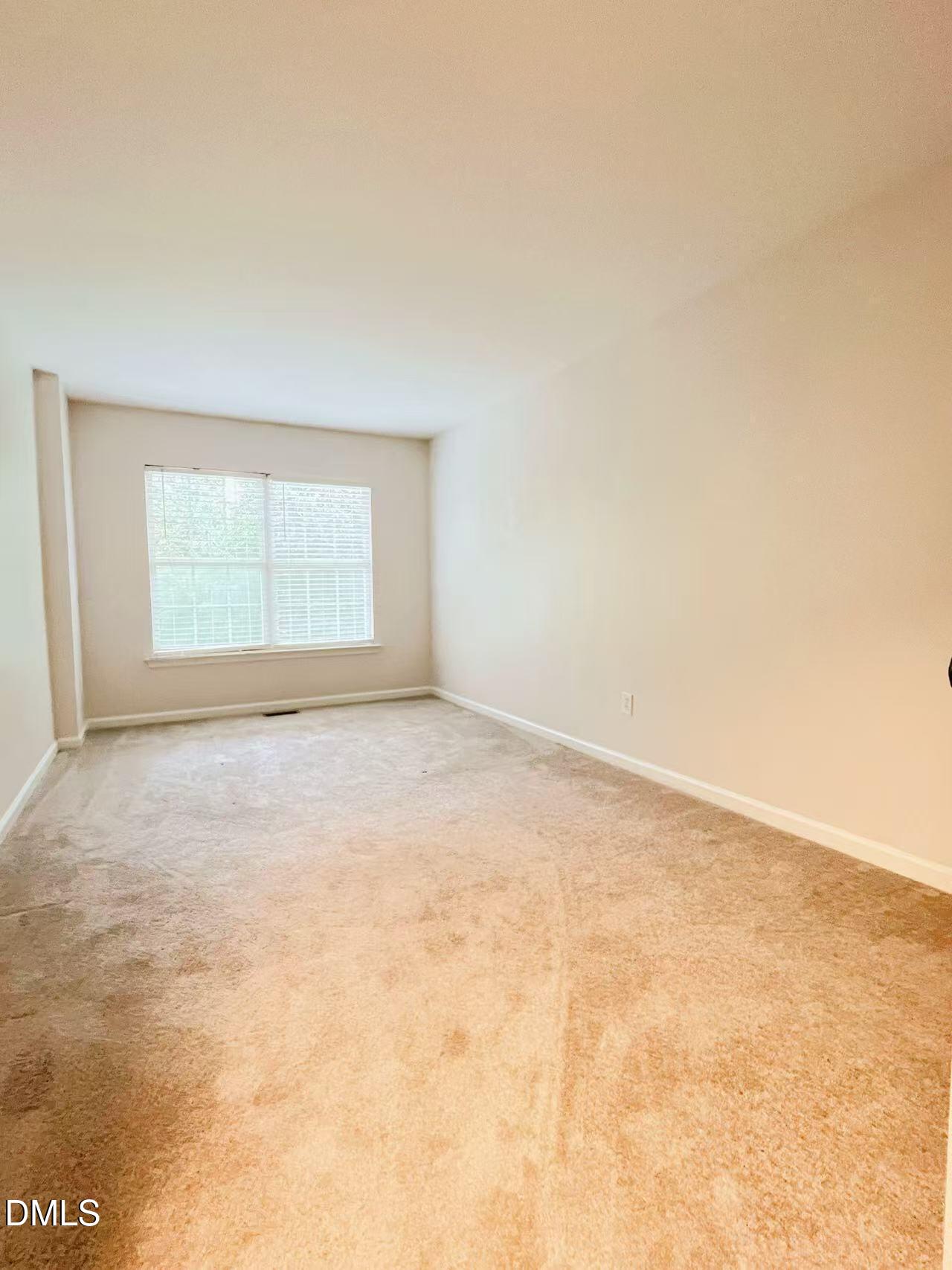 3040 Barrymore Street, Unit 108 Raleigh, NC 27603 - Photo 5 of 13 an empty room with a empty space and a window