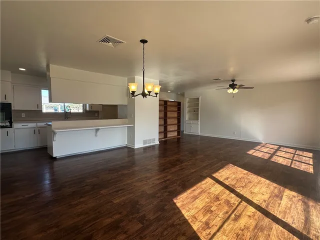 a view of a kitchen with a sink and a stove top oven