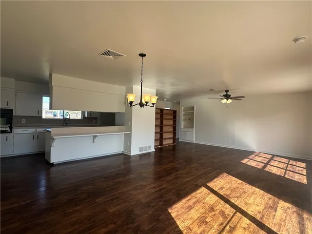 a view of kitchen with sink and wooden floor