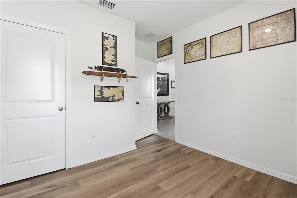 660 Hickory Course Loop Ocala, FL 34472 - Photo 25 of 45 an empty room with wooden floor and closet