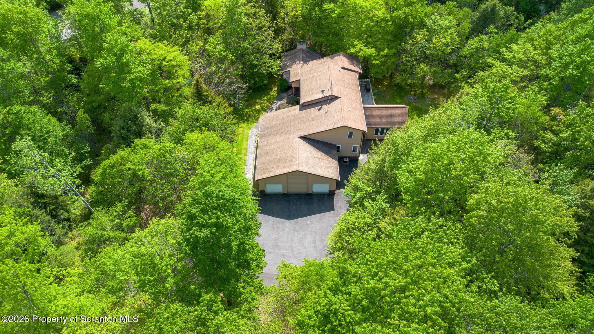 58 Bender Road Gouldsboro, PA 18424 - Photo 53 of 55 an aerial view of a house with outdoor space and trees all around