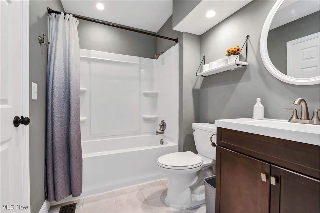 5141 Jaycox Road North Ridgeville, OH 44039 - Photo 21 of 36 Full bathroom featuring vanity, shower / bath combo with shower curtain, toilet, and tile patterned floors