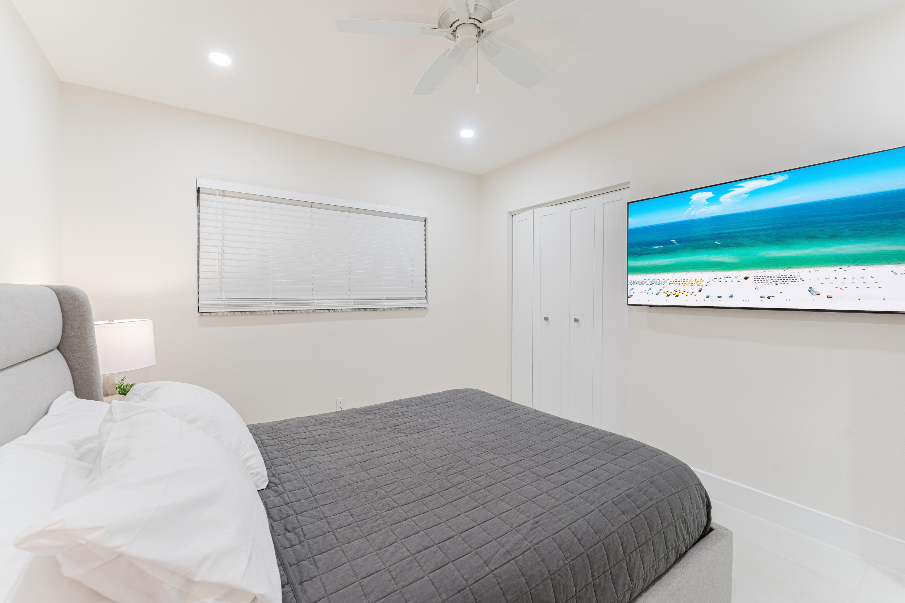 3199 Northeast 6th Drive Boca Raton, FL 33431 - Photo 34 of 49 a bedroom with a bed and a painting on the wall