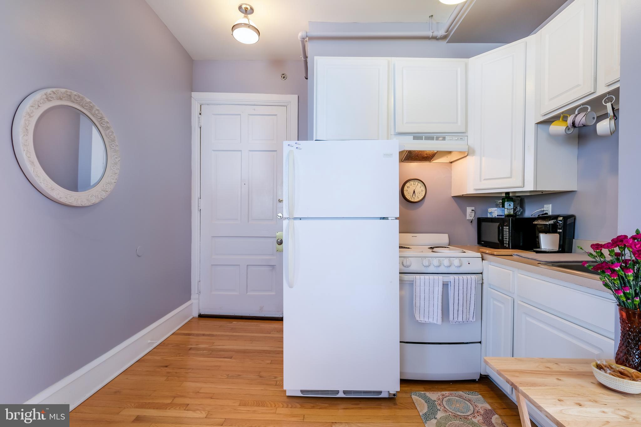 22 North Main Street, Unit 1 Doylestown, PA 18901 - Photo 22 of 22 a kitchen with a refrigerator and cabinets