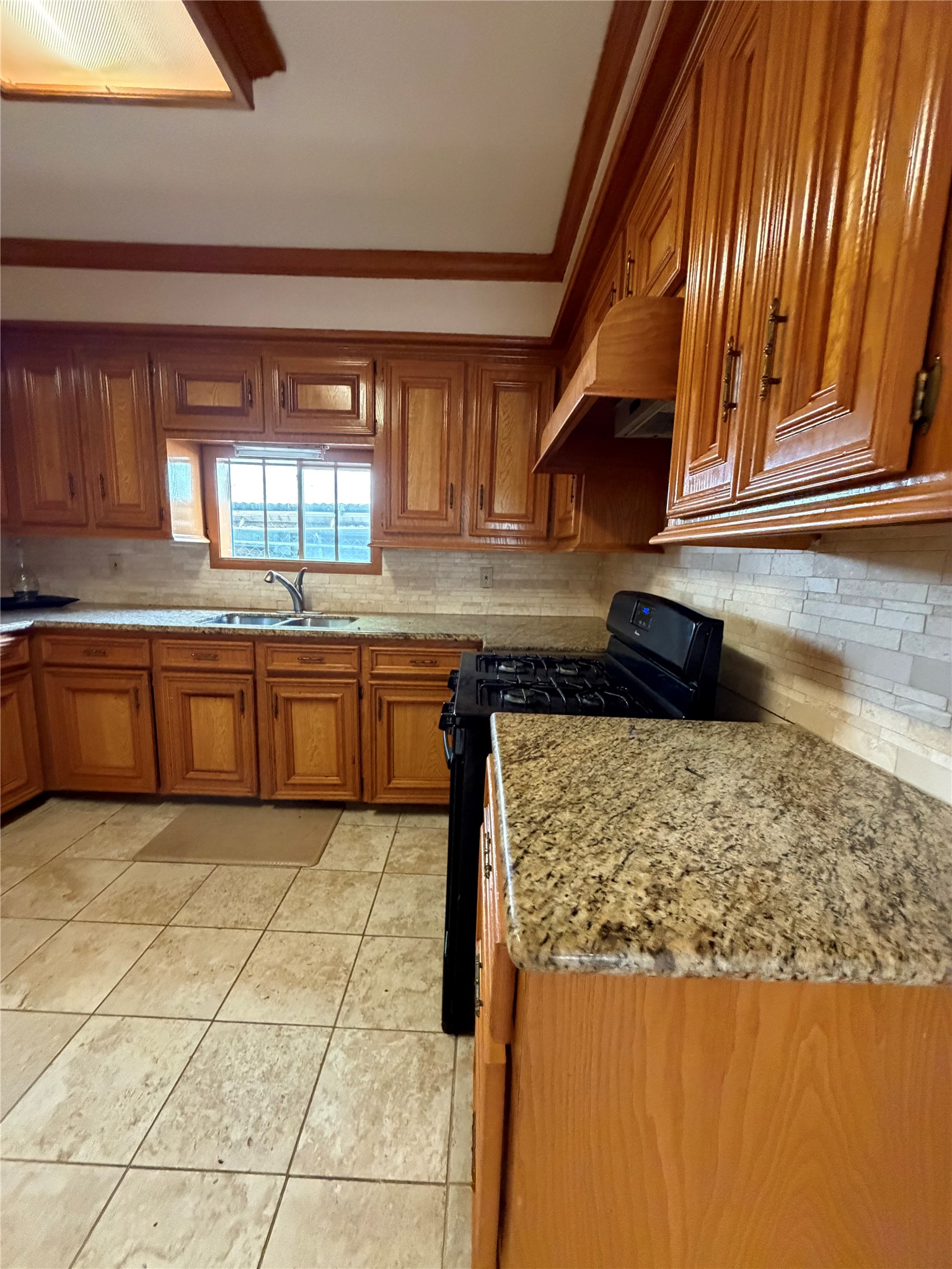 703 76th Street Houston, TX 77012 - Photo 13 of 23 a kitchen with stainless steel appliances granite countertop a sink and a stove