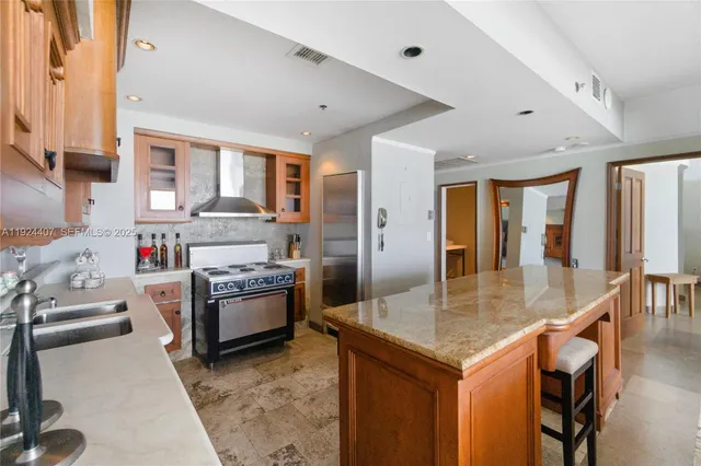 a kitchen with stainless steel appliances granite countertop a stove and a refrigerator