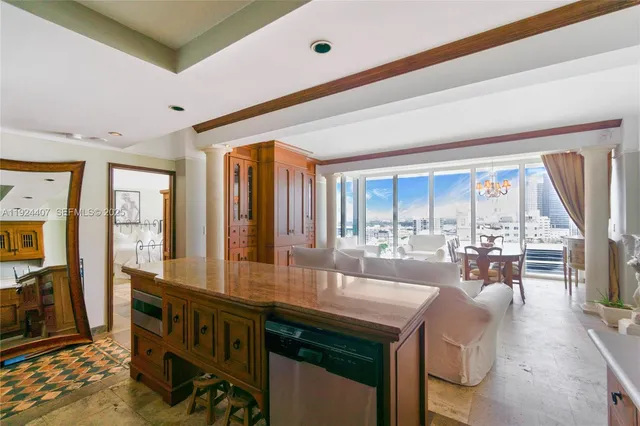 a very nice looking living room with a large window and dining table