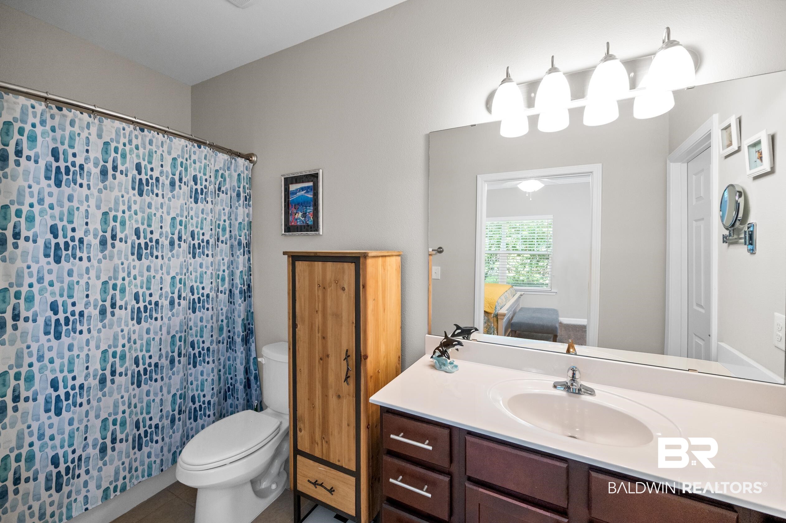 430 West Fort Morgan Road, Unit 1902 Gulf Shores, AL 36542 - Photo 23 of 59 Bathroom with tile patterned flooring, tile walls, toilet, and vanity