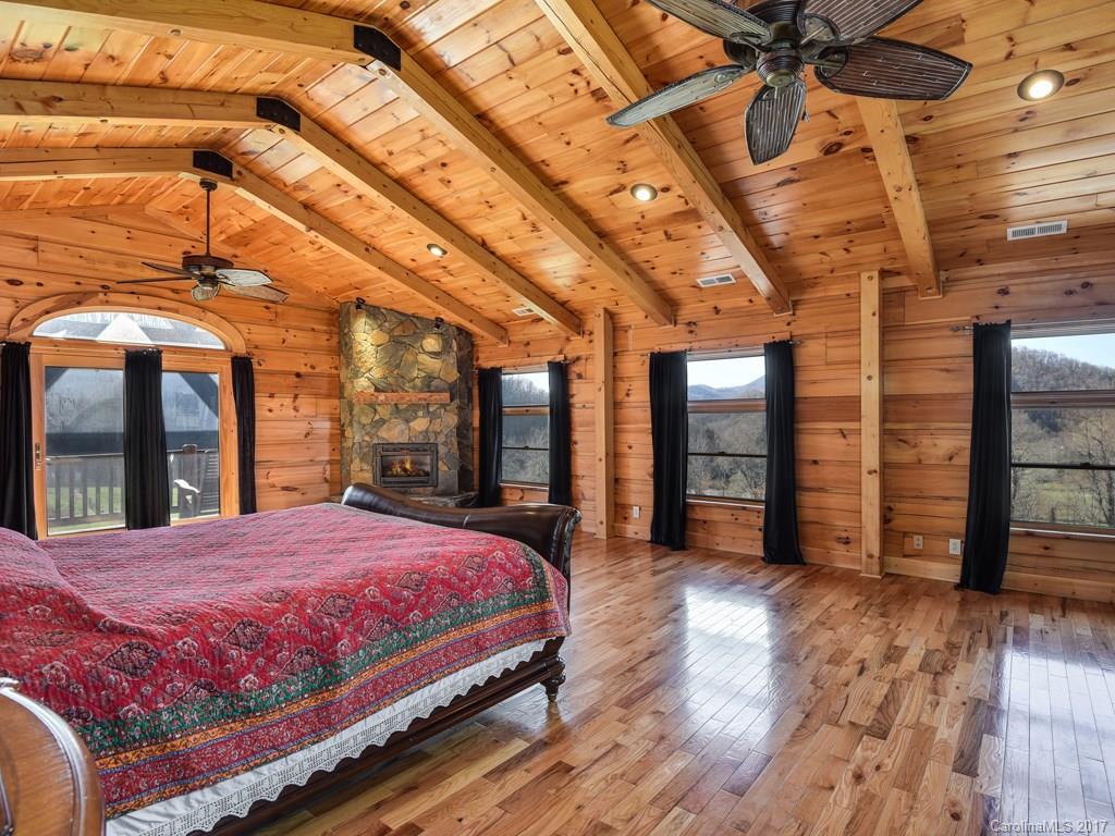 755 Poplar Cove Road Clyde, NC 28721 - Photo 8 of 24 a bed sitting in a spacious bedroom next to a window