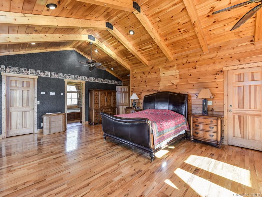 755 Poplar Cove Road Clyde, NC 28721 - Photo 9 of 24 a spacious bedroom with a bed and wooden floor