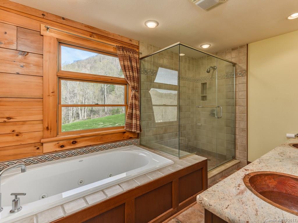 755 Poplar Cove Road Clyde, NC 28721 - Photo 10 of 24 a bathroom with a tub sink and shower