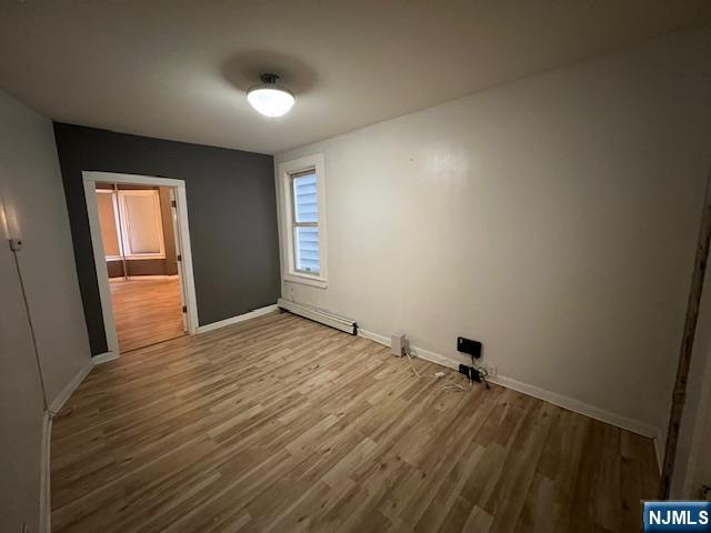108 Chester Avenue Newark, NJ 07104 - Photo 2 of 7 a view of empty room with wooden floor and fan