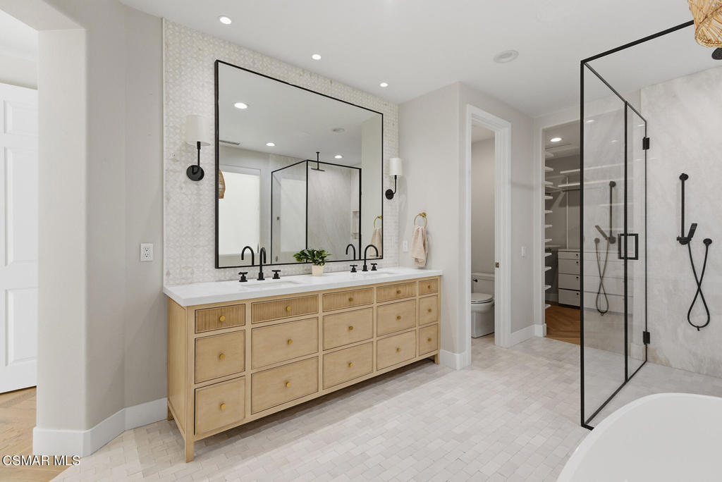 4630 Rio Bravo Court Moorpark, CA 93021 - Photo 20 of 43 a bathroom with a double vanity sink mirror double and shower
