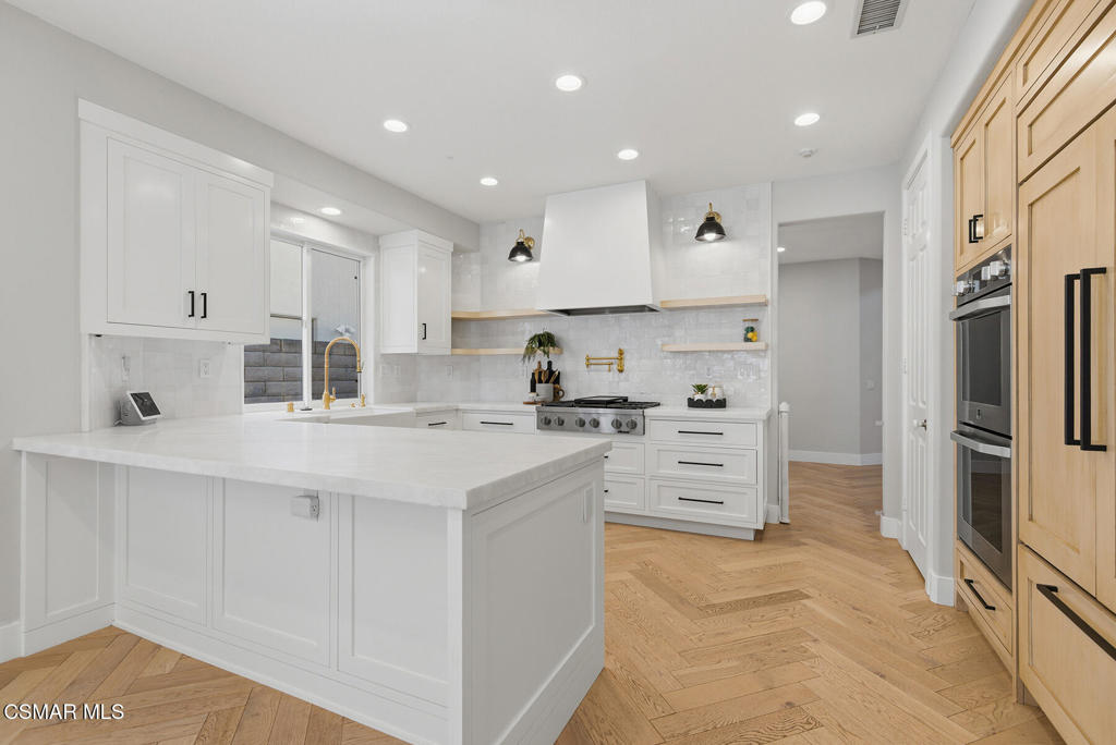 4630 Rio Bravo Court Moorpark, CA 93021 - Photo 3 of 43 a kitchen with white cabinets and stainless steel appliances