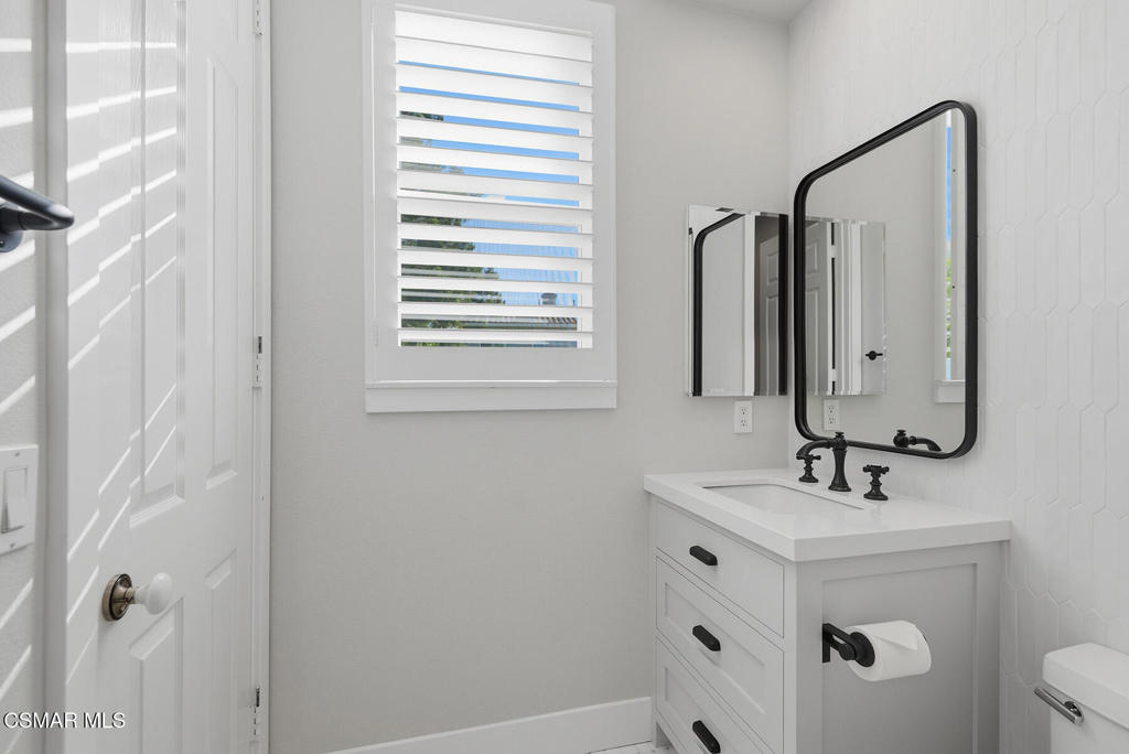 4630 Rio Bravo Court Moorpark, CA 93021 - Photo 33 of 43 a bathroom with a sink a toilet and a mirror
